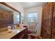 Bathroom with granite vanity and patterned shower curtain at 587 Hillcrest Dr, Largo, FL 33771