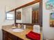 Bathroom vanity with granite countertop and large mirror at 587 Hillcrest Dr, Largo, FL 33771
