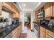 Galley kitchen features granite countertops and light wood cabinets at 587 Hillcrest Dr, Largo, FL 33771
