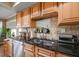 Double kitchen sink with granite countertop and light wood cabinets at 587 Hillcrest Dr, Largo, FL 33771