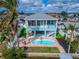 Elevated view showcasing the home's layout, pool, and canal access at 635 115Th Ave, Treasure Island, FL 33706
