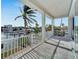 Balcony with water view and white railings at 635 115Th Ave, Treasure Island, FL 33706