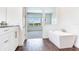 Spa-like bathroom with soaking tub and access to bedroom at 635 115Th Ave, Treasure Island, FL 33706