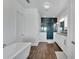 Modern bathroom with a walk-in shower and soaking tub at 635 115Th Ave, Treasure Island, FL 33706