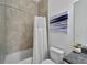 Clean bathroom with a shower/tub combo and tile surround at 635 115Th Ave, Treasure Island, FL 33706