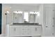 Elegant bathroom with double vanity, granite countertop, and a large mirror at 635 115Th Ave, Treasure Island, FL 33706