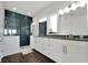 Elegant bathroom with double vanity and dark tile shower at 635 115Th Ave, Treasure Island, FL 33706