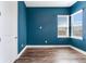 Spacious bedroom with blue walls and wood flooring at 635 115Th Ave, Treasure Island, FL 33706