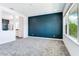 Large bedroom with grey carpet and a view into the bathroom at 635 115Th Ave, Treasure Island, FL 33706
