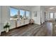 Bright entry with hardwood floors, decorative console table, and view to the dining area at 635 115Th Ave, Treasure Island, FL 33706