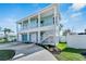 Two-story house with light blue exterior, white trim, and a two-car garage at 635 115Th Ave, Treasure Island, FL 33706