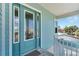Front entrance featuring a teal door with glass panels and white trim at 635 115Th Ave, Treasure Island, FL 33706