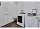 Bright laundry room with washer, dryer, and utility sink at 635 115Th Ave, Treasure Island, FL 33706