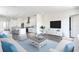 Bright living room with light colored furniture and blue accents at 635 115Th Ave, Treasure Island, FL 33706