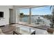 Living room with water view and sliding doors to balcony at 635 115Th Ave, Treasure Island, FL 33706