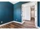 Bright office with dark blue walls and wood-look flooring at 635 115Th Ave, Treasure Island, FL 33706