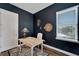 Dark-walled home office with desk and hardwood floors at 635 115Th Ave, Treasure Island, FL 33706