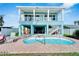 Relaxing kidney-shaped pool with brick surround, steps, and handrail at 635 115Th Ave, Treasure Island, FL 33706