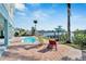 Inviting pool and brick patio area with lounge chairs, overlooking the water at 635 115Th Ave, Treasure Island, FL 33706