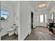 Modern powder room with white fixtures and dark hardwood floor at 635 115Th Ave, Treasure Island, FL 33706
