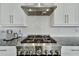 Stainless steel gas range with modern hood at 635 115Th Ave, Treasure Island, FL 33706