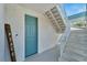 Exterior staircase leading to second floor, with seashell accent wall at 635 115Th Ave, Treasure Island, FL 33706