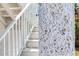 Seashell-embellished accent wall near exterior staircase at 635 115Th Ave, Treasure Island, FL 33706
