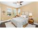 Cozy bedroom with a queen-size bed and wood floors at 6650 Current Dr, Apollo Beach, FL 33572