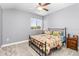 Comfortable bedroom with ceiling fan and large window offering natural light at 6650 Current Dr, Apollo Beach, FL 33572