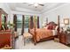 Spacious main bedroom with a post bed and wood flooring at 6650 Current Dr, Apollo Beach, FL 33572