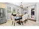Kitchen dining area with wooden table, upholstered chairs, and backyard access at 6650 Current Dr, Apollo Beach, FL 33572