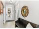 Bright entryway with tiled floor, bench, and decorative mirror at 6650 Current Dr, Apollo Beach, FL 33572