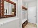 Inviting entryway with built-in bench, storage, and decorative mirror at 6650 Current Dr, Apollo Beach, FL 33572