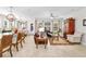 Open living room with leather furniture, large windows, and area rug at 6650 Current Dr, Apollo Beach, FL 33572