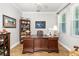 Home office with built-in bookcase and large desk at 6650 Current Dr, Apollo Beach, FL 33572