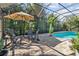 Inviting pool area with covered patio and lush landscaping at 6650 Current Dr, Apollo Beach, FL 33572