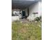 Cluttered backyard with miscellaneous items and debris at 7944 Shannon Ln, Zephyrhills, FL 33540