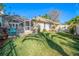 Spacious backyard with screened patio, lush lawn, and privacy fence at 1000 Chillum Ct, Safety Harbor, FL 34695