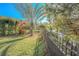 Landscaped backyard with lush greenery, a fence, and a canal view at 1000 Chillum Ct, Safety Harbor, FL 34695