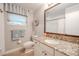Bright bathroom with granite countertop and shower/tub combo at 1000 Chillum Ct, Safety Harbor, FL 34695