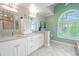 Elegant bathroom with double vanity, granite countertop and large mirror at 1000 Chillum Ct, Safety Harbor, FL 34695