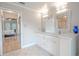 Bathroom with double vanity, granite countertop and view into bedroom at 1000 Chillum Ct, Safety Harbor, FL 34695