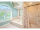 Bathroom with a large soaking tub and walk-in shower at 1000 Chillum Ct, Safety Harbor, FL 34695