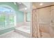 Relaxing bathroom with soaking tub and walk-in shower at 1000 Chillum Ct, Safety Harbor, FL 34695