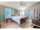 Spacious primary bedroom with wood floors and access to backyard at 1000 Chillum Ct, Safety Harbor, FL 34695