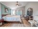 Main bedroom with wood floors, featuring a large bed and access to the private bath at 1000 Chillum Ct, Safety Harbor, FL 34695