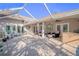 Relaxing covered patio with seating area and outdoor kitchen at 1000 Chillum Ct, Safety Harbor, FL 34695