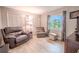 Relaxing sitting room featuring comfortable seating and built-in shelving at 1000 Chillum Ct, Safety Harbor, FL 34695