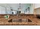 Granite countertop kitchen sink with a view into the living room at 12000 Gulf Blvd # 309N, Treasure Island, FL 33706
