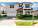 Two-story house with three-car garage, landscaping and paver driveway at 21680 Violet Periwinkle Dr, Land O Lakes, FL 34637